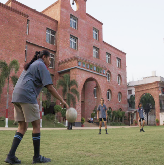 Energetic girls from MBIS participating in a competitive handball game.
